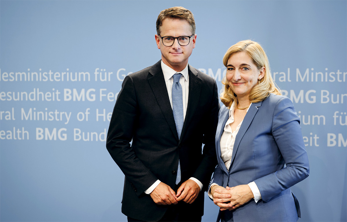 Carsten Linnemann standing beside Nina Warken in front of a Federal Ministry of Health backdrop