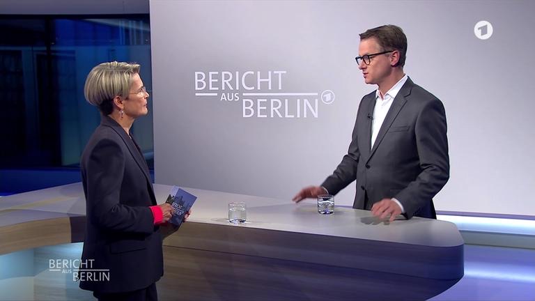 Carsten Linnemann in a studio interview with a presenter on the ARD programme Bericht aus Berlin
